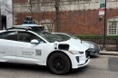 A Google-operated Waymo vehicle drives through Chicago’s Near North Side, with a driver, as the company begins testing and mapping the city in March 2026.