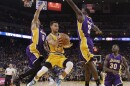 Golden State Warriors guard Stephen Curry, center, looks to pass as Los Angeles Lakers Jordan Clarkson (6), Brandon Bass (2) and Julius Randle (30) defend. The Warriors won, 111-77.