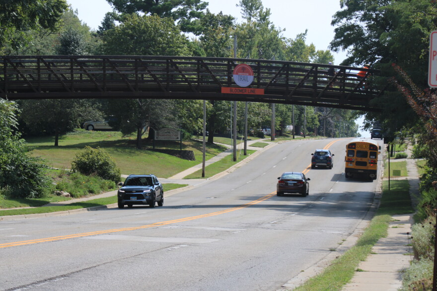 A bridge going over a street with signage reading, "Constitution trail; Bloomer Line" 