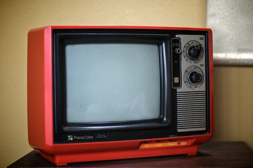 An orange PanaColor television. 