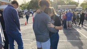 Two teens embrace at a prayer vigil on Sunday, April 16, 2023, outside First Baptist Church in Dadeville, Ala. Several people were killed and over two dozen were injured in a shooting at a teen birthday party in the town on Saturday, April 15. (AP Photo/Jeff Amy)