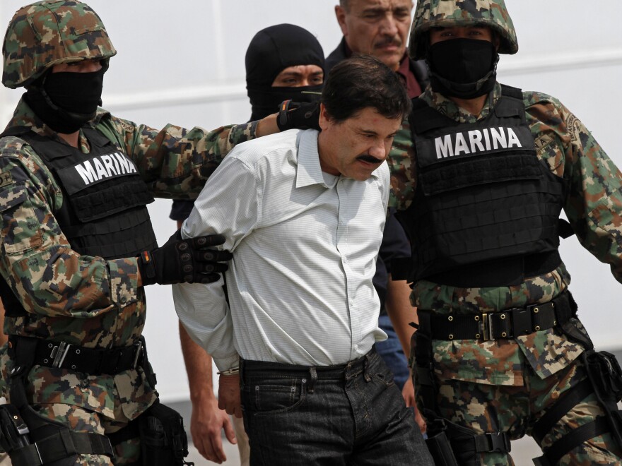 Mexican navy marines escort Joaquin "El Chapo" Guzman, the head of Mexico's Sinaloa Cartel, in handcuffs to a helicopter in Mexico on Saturday.