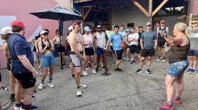 Mari Barlow (2nd from right) shares community running updates at the start of a Runaways event at Oxbow Brewing Co. in July.