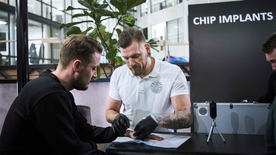 Osterlund implants a chip into a man in Stockholm. More than 4,000 Swedes have adopted the technology.