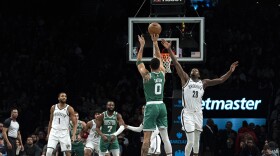 Boston Celtics forward Jayson Tatum (0) shoots against Brooklyn Nets forward Dorian Finney-Smith (28) during the first half of an NBA basketball game in New York, Tuesday, Feb. 13, 2024. (AP Photo/Peter K. Afriyie)