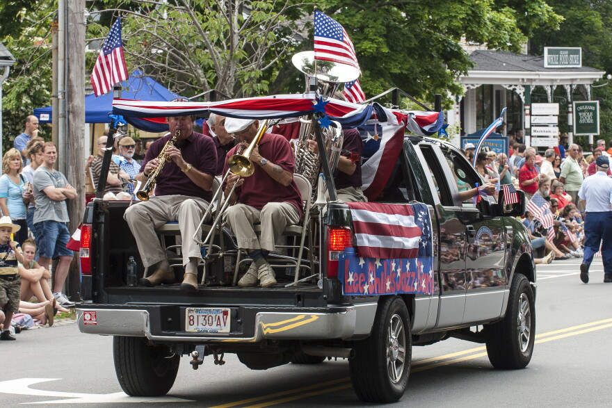 Teens and adults celebrate during the 4th of July parade. Cape Cod, Massachusetts.