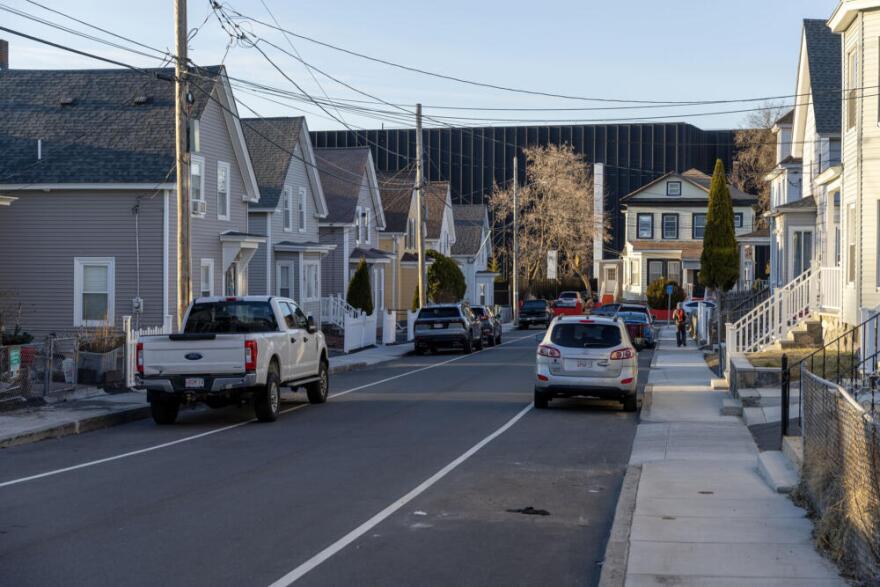 The Markley Lowell datacenter rises above houses on Otis Street, in Lowell, Mass. (Robin Lubbock/WBUR)