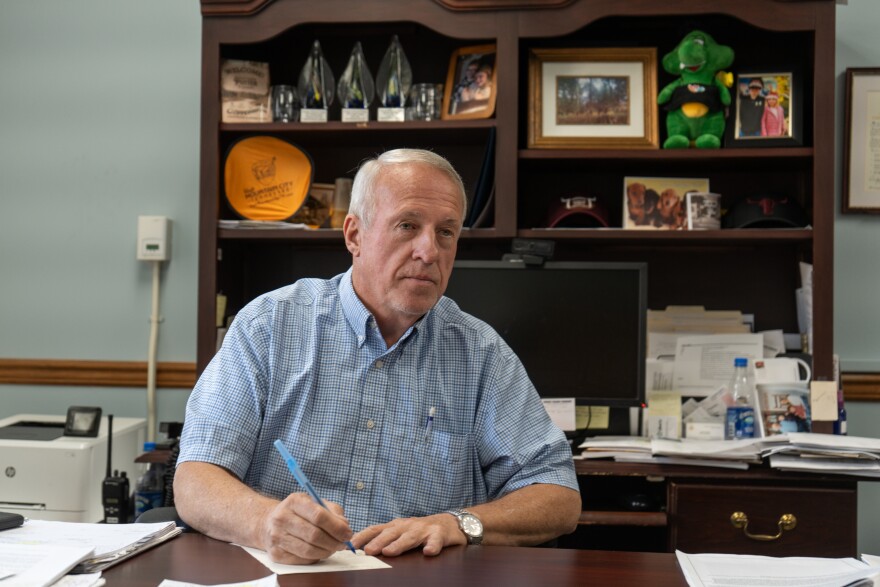 Johnson County Mayor Larry Potter working at his desk on Friday, Sep. 12, 2025. Potter says his county, which is labeled by the state as “at-risk of being distressed,” is struggling to come up with the money to rebuild roads and bridges that were destroyed by Hurricane Helene last year.