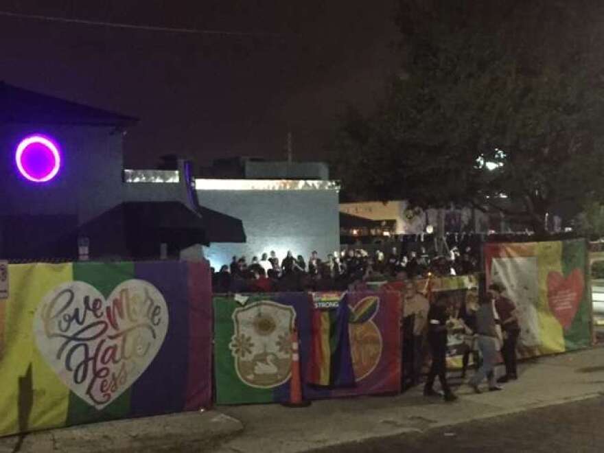 A small crowd gathered near the entrance of Pulse to remember the victims./Photo: Catherine Welch