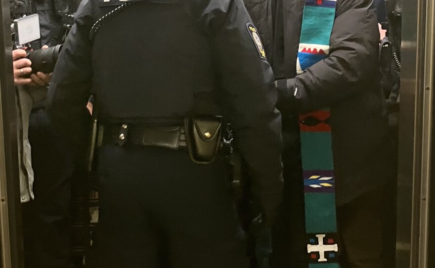 Pastor Will Green, of New Brackett Church on Peaks Island, being arrested by Portland police.