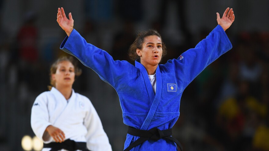 Kosovo's Majlinda Kelmendi celebrates winning the gold medal over Italy's Odette Giuffrida in the women's 52-kilogram (114-pound) weight class. This is Kosovo's first time at the Olympics, and Kelmendi's victory marked its first medal.