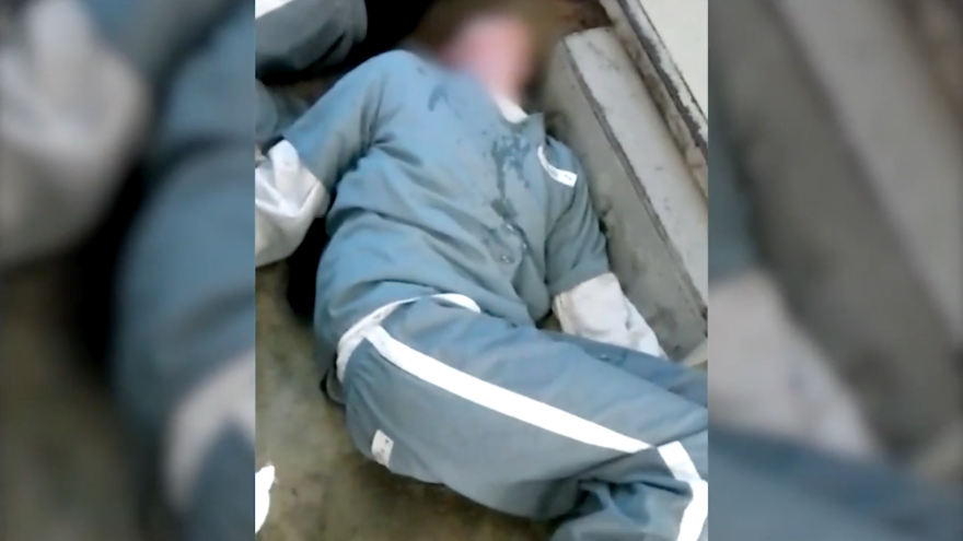 An inmate lays on the ground after smoking synthetic marijuana.