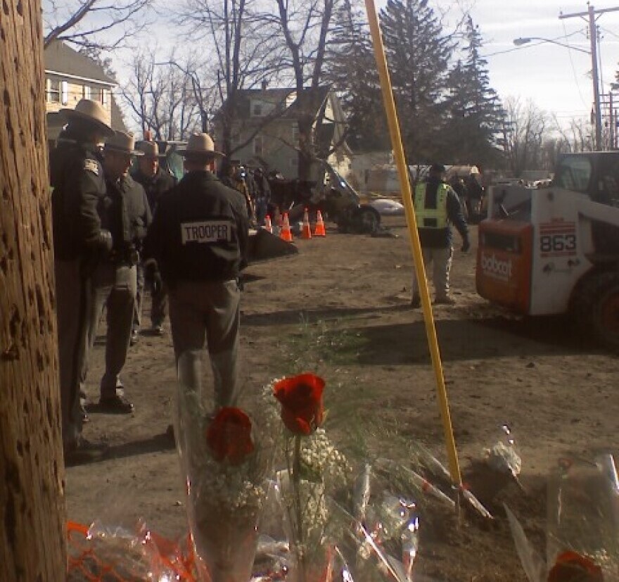 New York State Troopers assess the aftermath of the crash of Flight 3407 in Clarence.