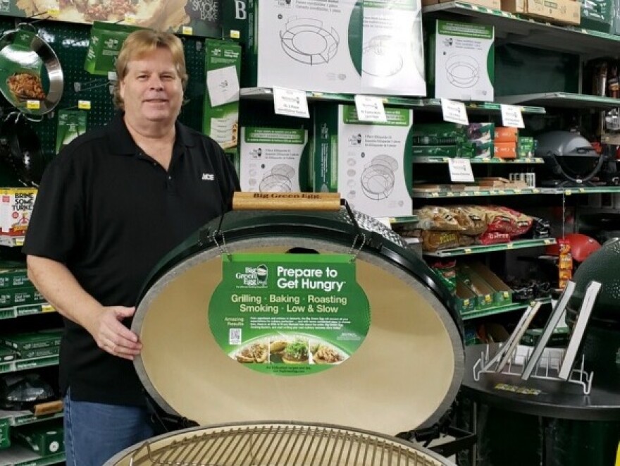 Palm Beach Gardens Ace Hardware General Manager Joe Lingelbach and one of his store's best sellers during to the pandemic – a Big Green Egg grill.