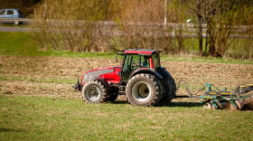 A red tractor on a farm field