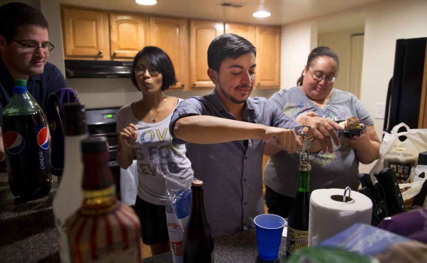 Younes celebrates his birthday with Martinez (second from left) and several of their friends at their apartment on a Saturday night.