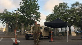 National guard troops stand outside the entrance to Mahalia Jackson theater on the first day of the drive through testing program aimed at healthcare workers and first responders. 
