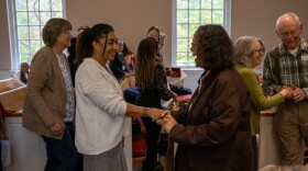 Natasha Lovelace shakes hands with a member of Forest Hill Church. 