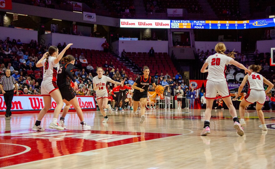 Girls high school basketball players inside an arena