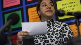 Ms. Vasquez’s eyes well up with tears as she describes to reporters the incident in which she and her 15-year-old daughter were violently assaulted on Feb. 15 by two white women near Maverick Station in East Boston. (Jesse Costa/WBUR)