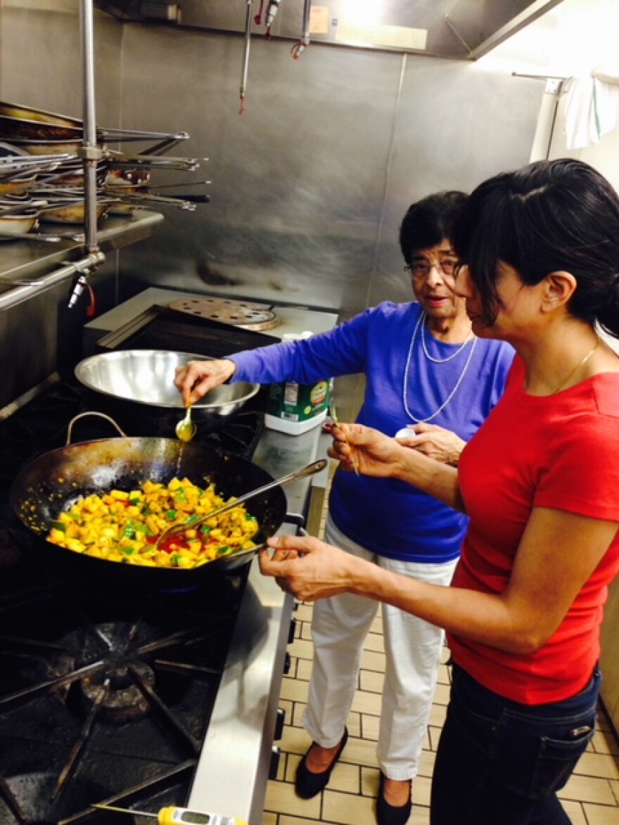 Cheetie Kumar preparing food with her mother in the kitchen at Garland restaurant. 