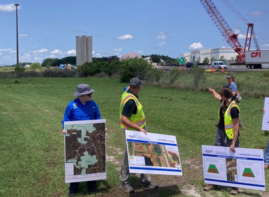 Officials point to the construction site at Interstate 4