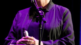 Lois Lowry plays a game called "Product Placement" on the Ask Me Another stage at Wilbur Theatre in Boston.