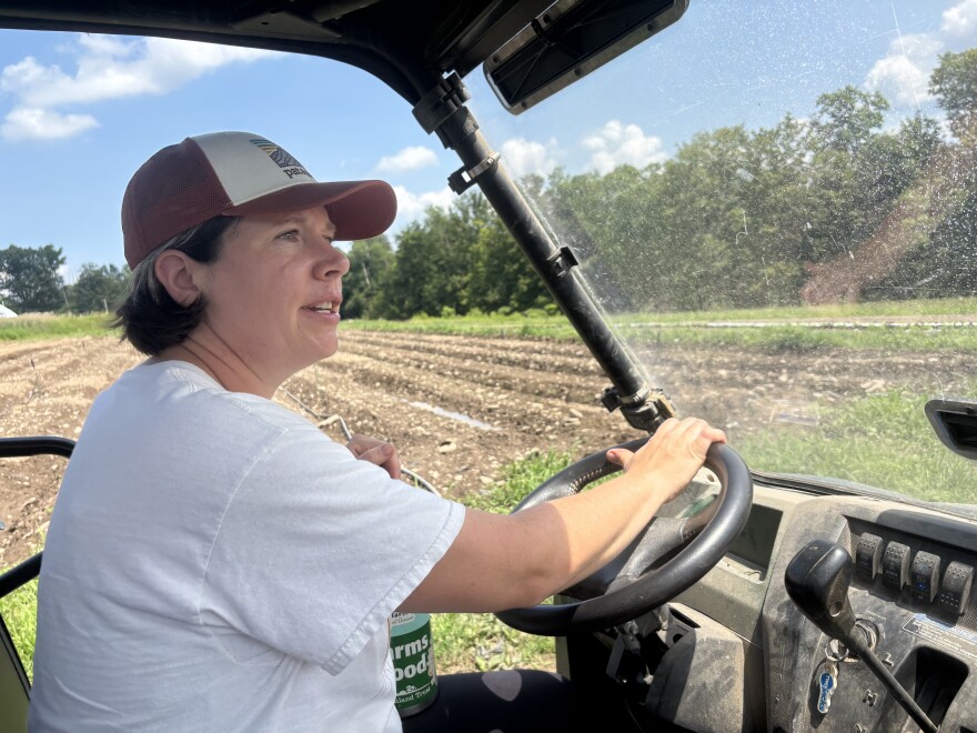 Liz Krug drives a cart around her farm, Endless Roots Farm, on July 30, 2025 in Waverly, PA.
