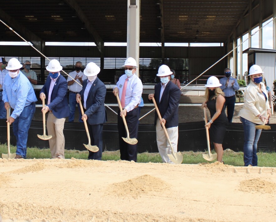 The people involved in the creation of the UF/IFAS Extension Alachua County Headquarters project come together to celebrate by breaking ground with shovels. (Ashlyn Jones/WUFT News)