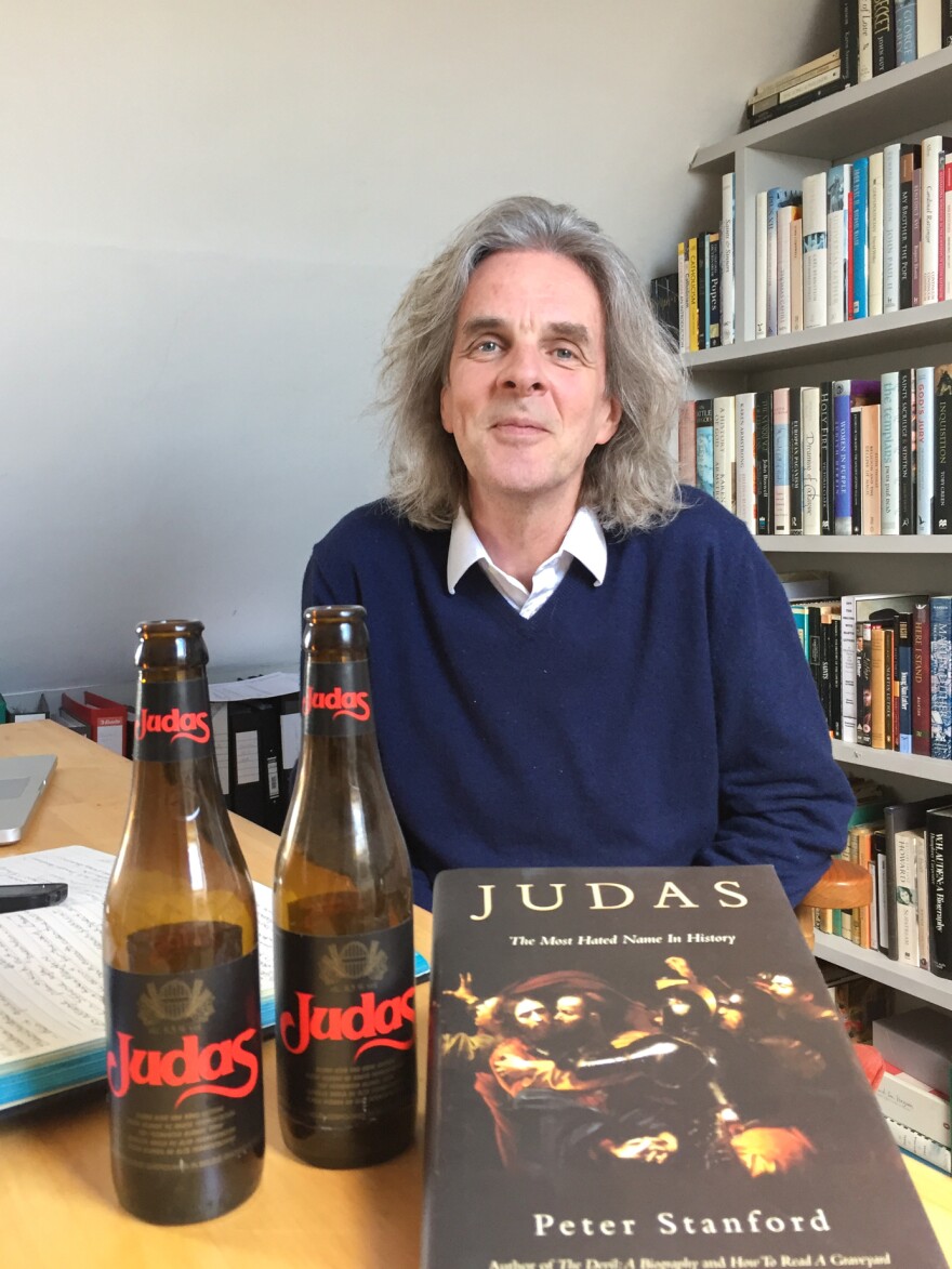 Peter Stanford poses with his book <em>Judas: The Most Hated Name in History</em> and two bottles of Judas, a Belgian beer that looks pale but is treacherously strong.