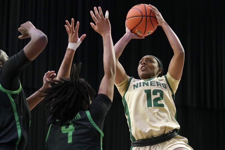 North Texas guard Jazion Jackson (4) defends as Charlotte guard Mikayla Boykin (12) shoot during the first half of an NCAA college basketball game in the semifinals of the Conference USA women's tournament in Frisco, Texas, Friday, March 11, 2022.