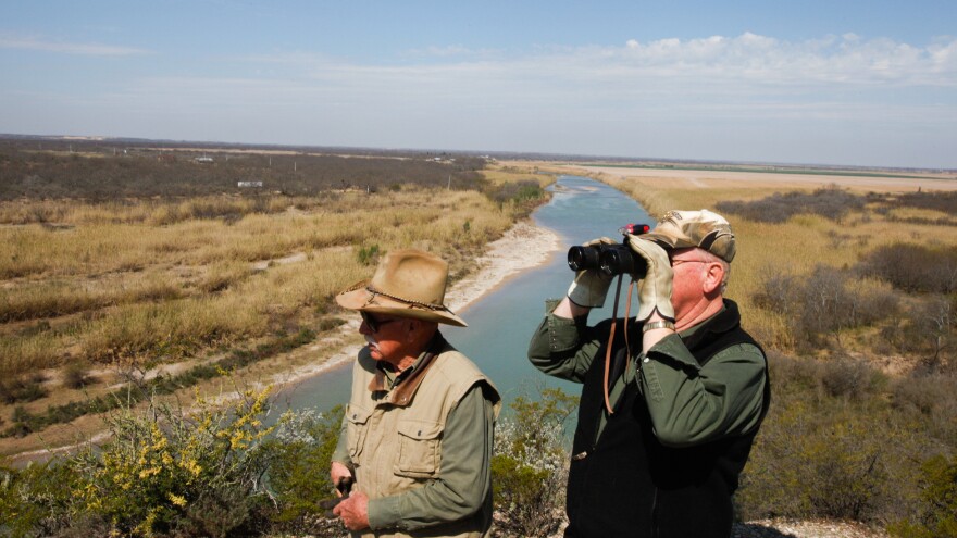 Dob Cunningham (left) and his friend Larry Johnson look over the edge of Cunningham's 800-acre ranch in Quemado, Texas.