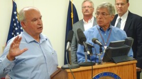 B.C. Mines Minister Bill Bennett discusses the week’s mine meetings as Lt. Gov. Byron Mallott and other state officials listen during a Wednesday press conference in Juneau. (Photo by Ed Schoenfeld/CoastAlaska News).