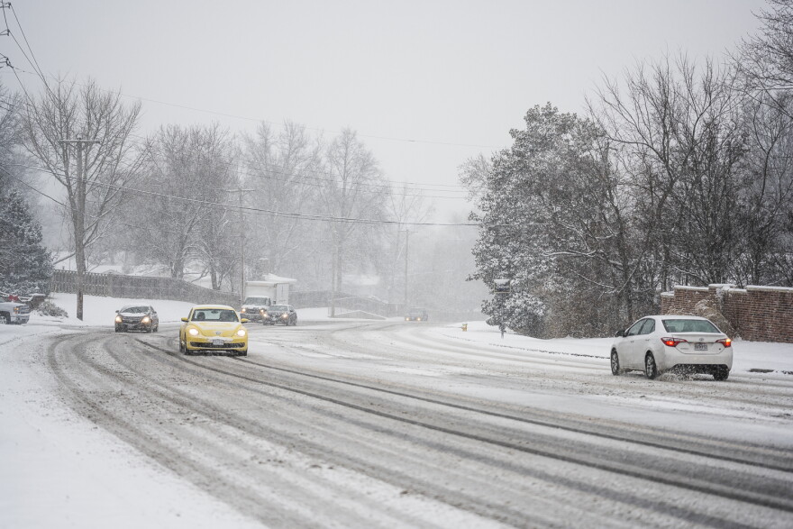 Cars lurch along on snow-covered roads in Ballwin. Many parts of the St. Louis region reported more than 6 inches of snow accumulation by Monday afternoon, according to 5 On Your Side. 
