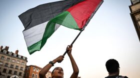 A protester waves a Palestinian flag during a rally called by 'Collectif 69' in support of Palestinians in Lyon, southeastern France.