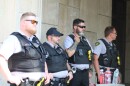 Law enforcement officers from different agencies watched as demonstrators dismantled an encampment outside local government office buildings on July 1.