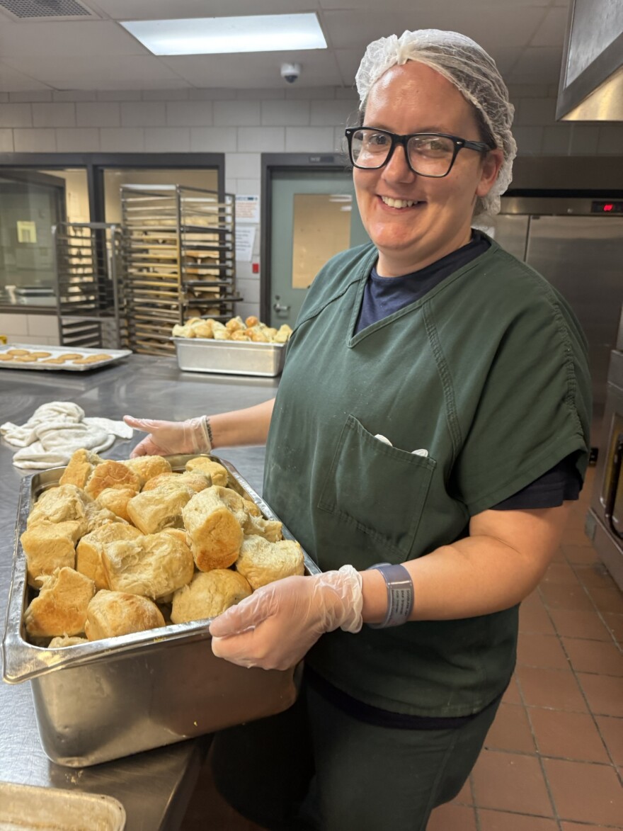 Barnstable County inmate Amy Douglass carries dinner rolls.