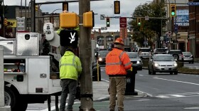 Workers conduct maintenance on a crosswalk on State Street at the intersection of Morrie Silver Way on Oct. 23, 2025.
