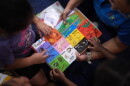 Children look through a book of first words at a Head Start preschool in Immokalee, Fla., Thursday, Sept. 10, 2026.