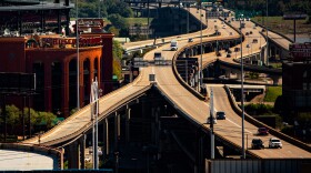Cars drive down Interstate 64 and U.S. Route 40 on Monday, Oct. 18, 2021, in St. Louis, Missouri. Busch Stadium, home of the St. Louis Cardinals, is on the left.