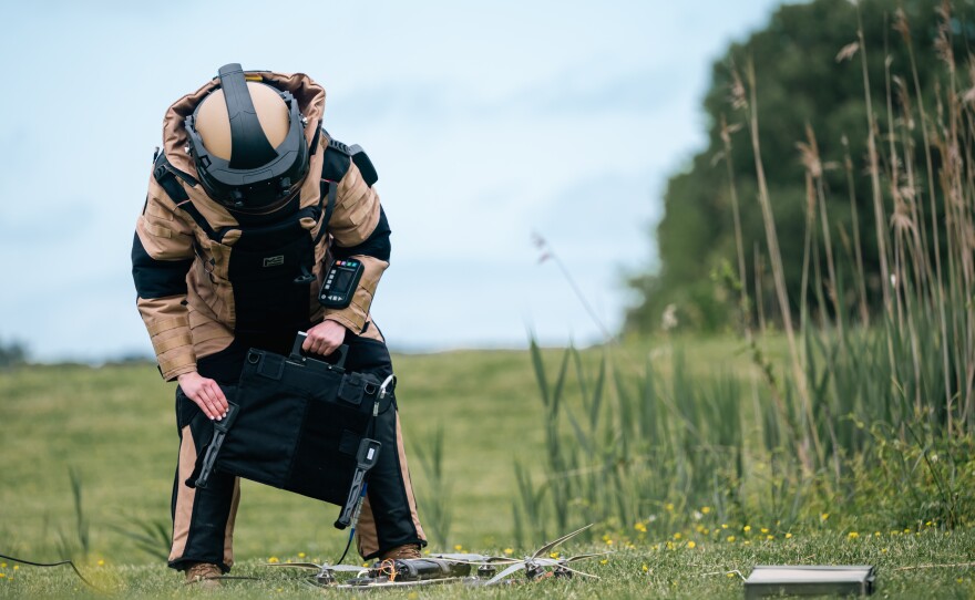 Air Force Staff Sgt. Amanda Hungness neutralizes a downed drone during an April 2024 exercise at Langley Air Force Base in Virginia. The joint exercise with NASA tested the ability of airmen to dismantle and destroy potentially dangerous drones.