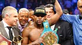 Floyd Mayweather Jr. celebrates the unanimous decision victory during the welterweight unification championship bout on Saturday at MGM Grand Garden Arena in Las Vegas.