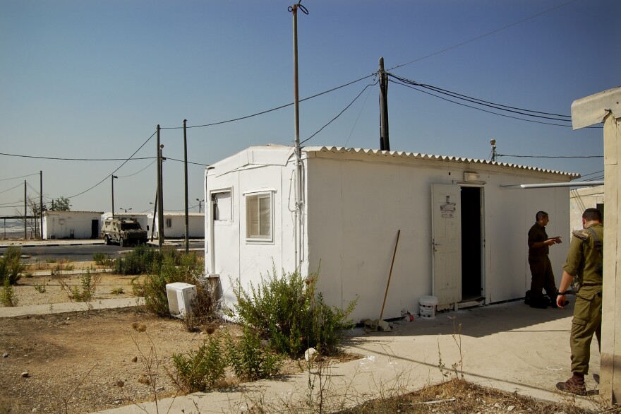 A white metal trailer serves as the makeshift synagogue at the West Bank outpost of an all-ultra-Orthodox Israeli military platoon.