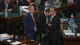 Suspended Attorney General Ken Paxton (left) stands with his attorney Tony Buzbee in the Texas Senate chambers on the first day of his impeachment trial.