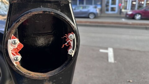 Old parking meter with scraps of plastic and metal.