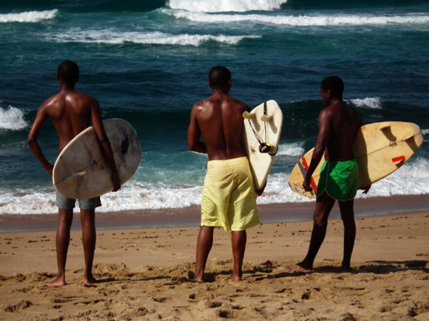 Otelo, Mandla (Silhe Xaba, center) and New Year escape the turmoil around them by taking to the waves and training to compete professionally.
