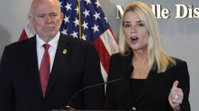 Attorney General Pam Bondi speaks as U.S. Attorney of Middle District of Florida Gregory W. Kehoe, left, watches during a human smuggling news conference Thursday Sept. 4, 2025, in Tampa, Fla. (AP Photo/Chris O'Meara)
