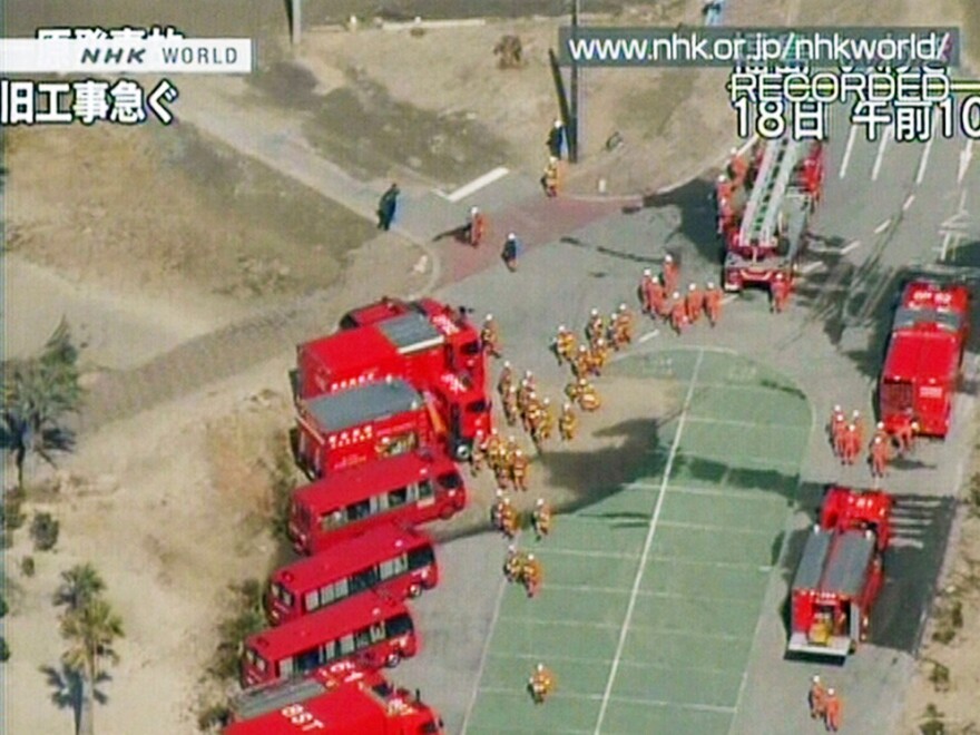 A screen grab from Japanese public broadcaster NHK shows a fleet of firetrucks preparing to cool the quake-hit nuclear plant in the town of Okuma in Fukushima prefecture on March 19.