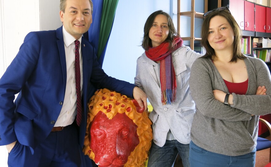 Slupsk Mayor Robert Biedron (from left) and LGBT activists Marta Abramowicz and Marta Kosinska stand next to a symbolic Gdansk lion statue painted in rainbow colors in honor of the city's first gay rights march, held in May.