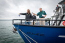Michigan Department of Natural Resources Deputy Director Shannon Lot pours water over the bow of the RV Steelhead to christen it at the Sept. 30 ceremony.